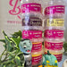 A stack of ten Beau's Professional blended flavor sugarpaste tubs in various colors, arranged with decorative props including a green plant, a small gray monster figurine, and a green pumpkin decoration against a white background with a pink logo.